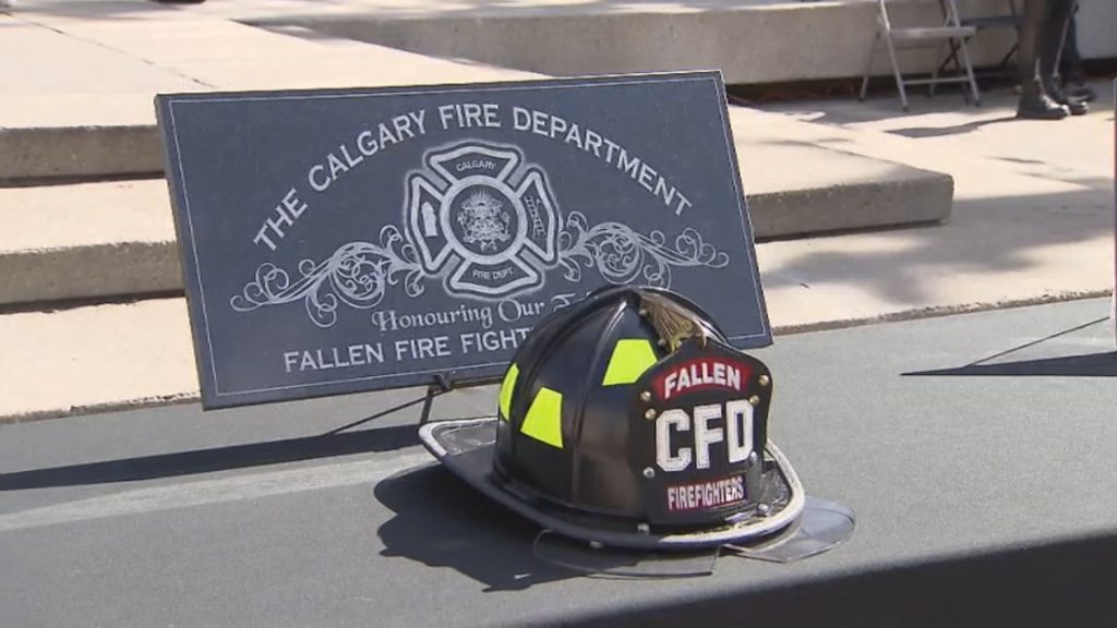Calgary Firefighters A Calgary Fire Department helmet lies next to a memorial for firefighters