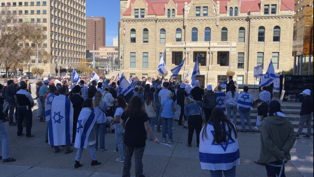 Dozens rally outside the Municipal building in Calgary on Monday, Oct. 9, 2023. (Silvia Naranjo, CityNews image)