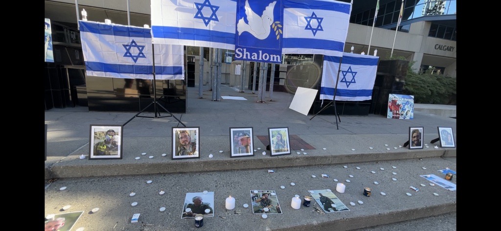 Pictures of victims lost in Israel outside the Municipal building in Calgary