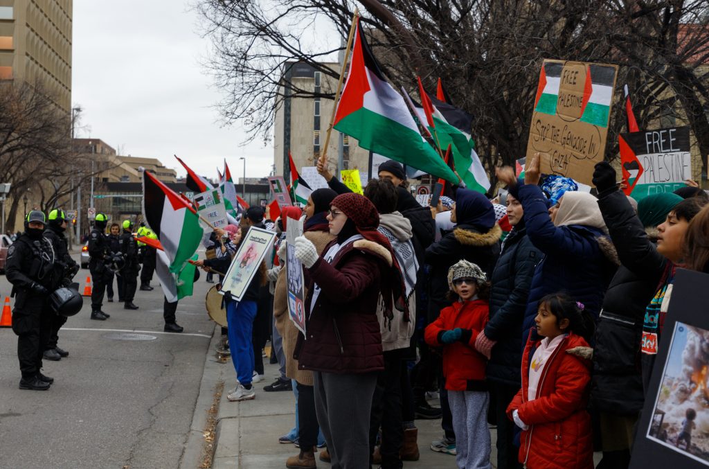 People rally in support of Palestine in front of the Municipal Building in downtown Calgary 