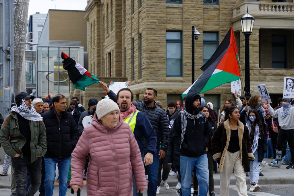 People march in support of Palestine towards the Harry Hays Building from the Municipal Building in downtown Calgary