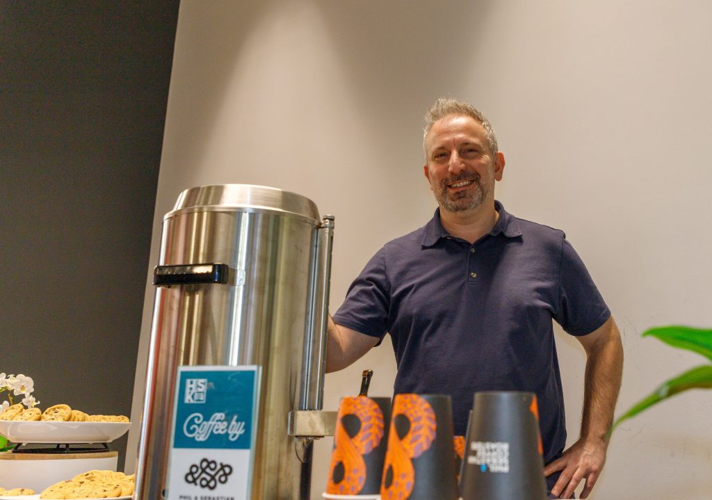 Rob Oppenheim poses for a photo at his free coffee booth at the new Food Services inside Mathison Hall at the University of Calgary in Calgary