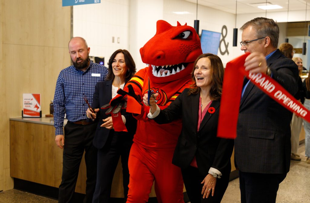 From left to right: Steve White, Louise Hudson, Rex, Catherine Haggard, and Tony Migliarse react after the ribbon was cut for the new Food Services at Mathison Hall at the University of Calgary in Calgary