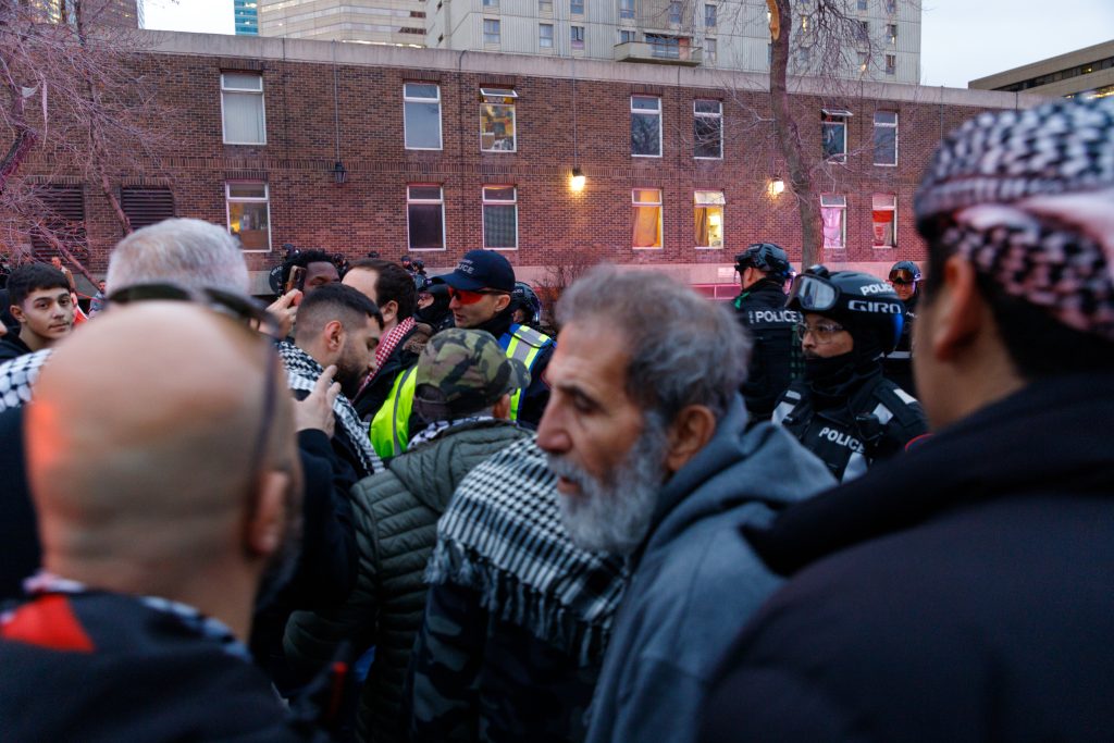 Pro-Palestine protestors meet with police on Macleod Trail and 5 Avenue SE in downtown Calgary