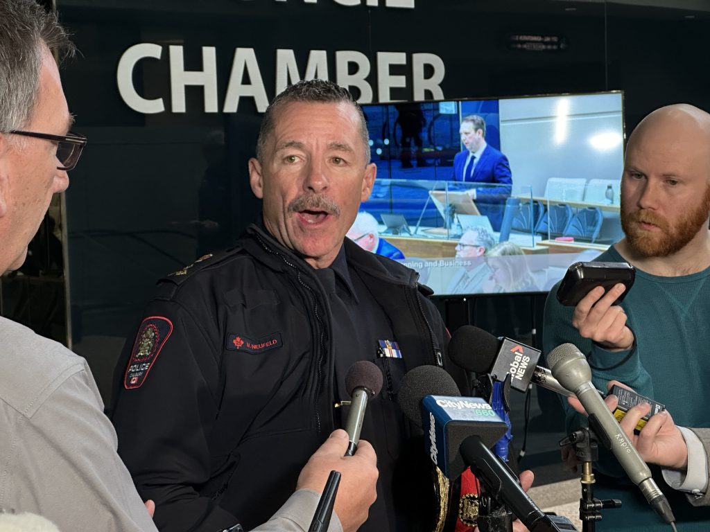Calgary police Chief Mark Neufeld speaks to media outside Calgary council chambers following budget deliberations on Tuesday, Nov. 21, 2023.