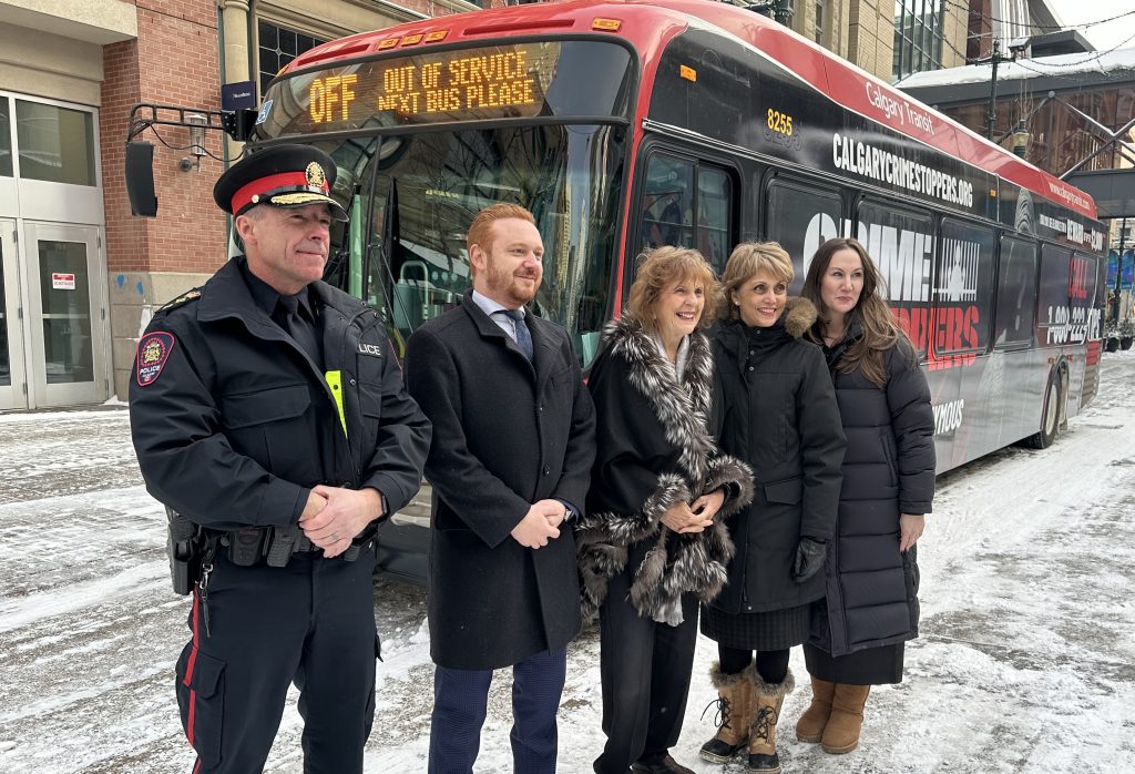 A new Calgary Transit bus wrapped in Crimestoppers print was unveiled Thursday. Mayor Jyoti Gondek, Police Chief Mark Neufeld, Minister of Justice Mickey Amery, and former Lt. Gov. Loise Mitchell were present. (Jillian Code, CityNews image)