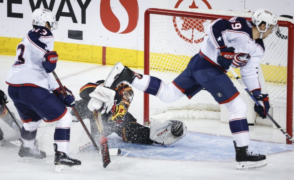 Columbus Blue Jackets forward Yegor Chinakhov (59) scores on Calgary Flames goalie Jacob Markstrom (25) during first period NHL hockey action in Calgary, Thursday, Jan. 25, 2024. THE CANADIAN PRESS/Jeff McIntosh