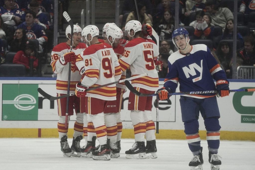 Calgary Flames players celebrates a goal during the second period of an NHL hockey game against the New York Islanders, Saturday, Feb. 10, 2024, in New York