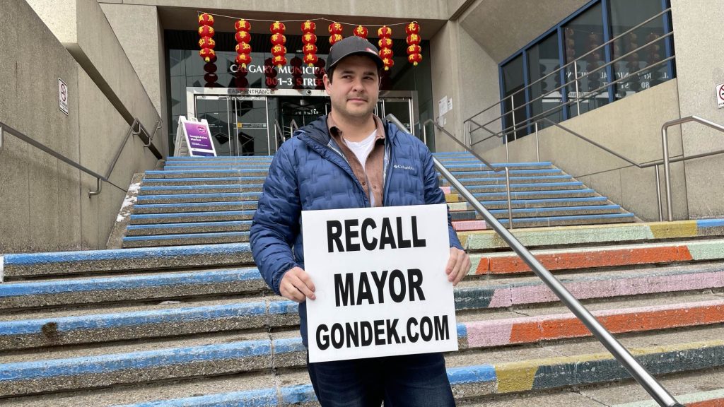 Landon Johnston poses for a photo by steps that lead to the Municipal Building in Calgary