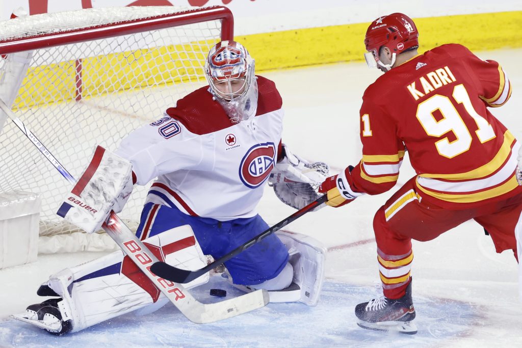Montreal Canadiens goalie Cayden Primeau (30) is scored on by Calgary Flames' Nazem Kadri during third period NHL hockey action in Calgary, Alta., Saturday, March 16, 2024