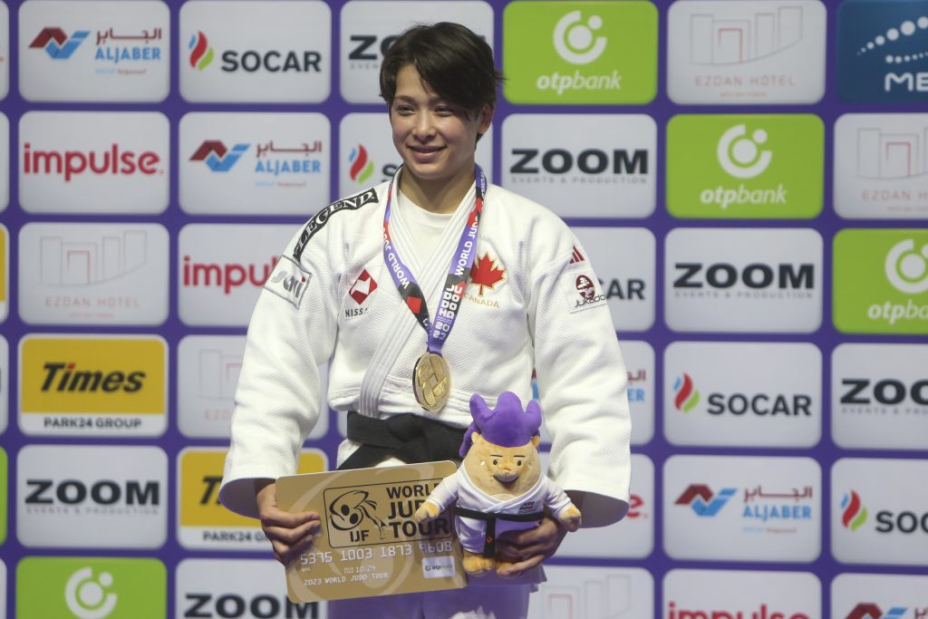 Gold medalist Christa Deguchi of Canada poses during the medal ceremony for women's -57kg competition at the World Judo Championships in Doha, Qatar, Tuesday, May 9, 2023.