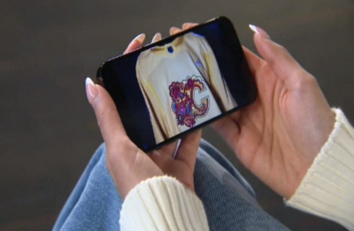 Zoe Harveen Kaur Sihota looks at the South Asian Celebration jersey on her phone in Calgary on Friday, March 29