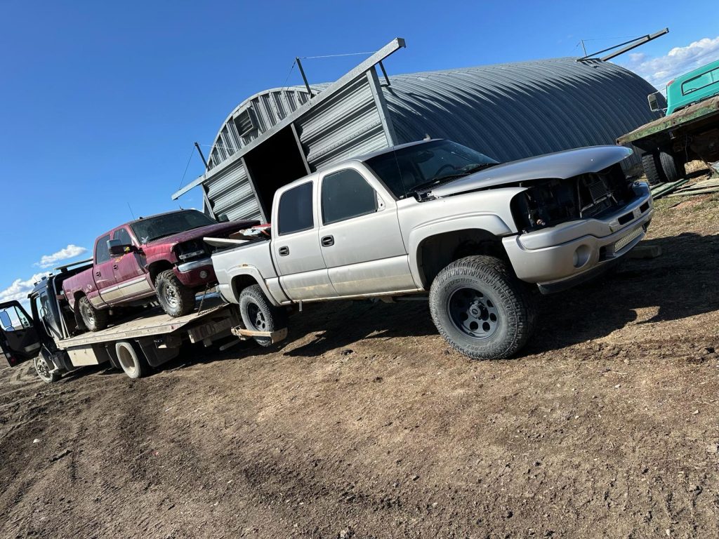 Police officers found 12 stolen pick-up trucks, a stolen travel trailer, two stolen utility trailers, and two stolen dirt bikes at a rural property in Vulcan County on April 9, 2024. A thirty-year-old man from Okotoks is now facing charges. (Courtesy RCMP)