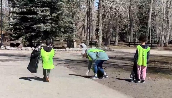 Volunteers with Keep the Earth Fresh pick up trash as part of an annual cleanup in Prince's Island Park in Calgary on Saturday, April 20, 2024.