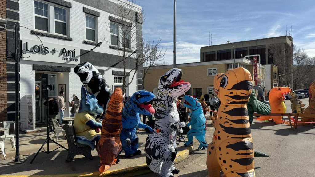 People wear dinosaur costumes for the Jurassic Jamboree in Drumheller on Saturday, April 27, 2024.