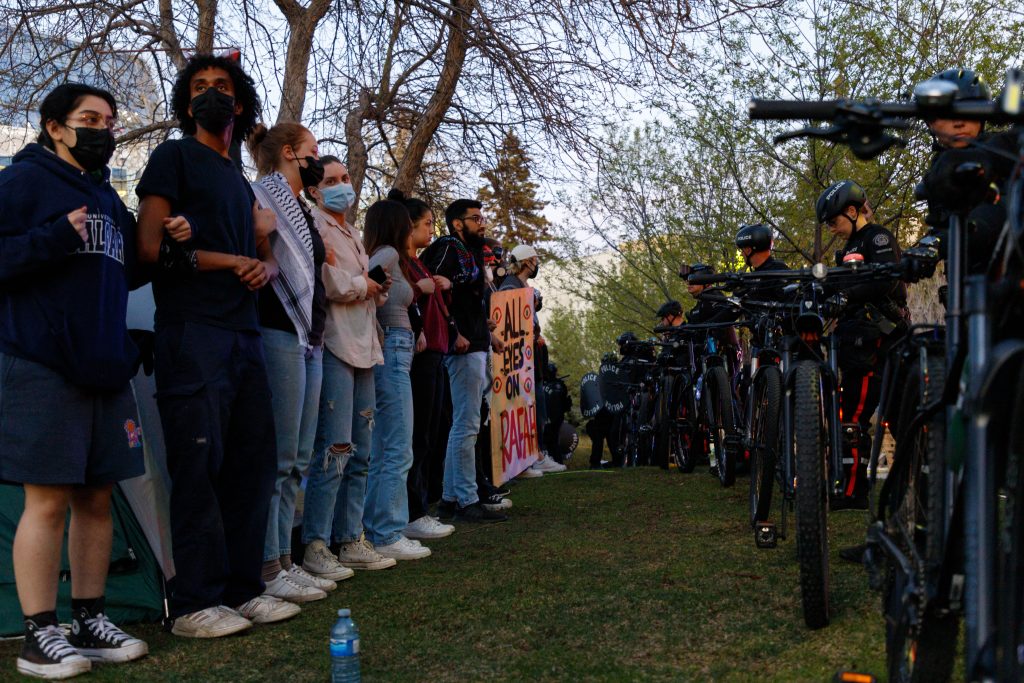 Calgary police and students in a pro-Palestinian encampment at the University of Calgary grounds by MacEwan Hall face off after police tore down most of the tents in Calgary on Thursday, May 9, 2024. (Alejandro Melgar, CityNews).