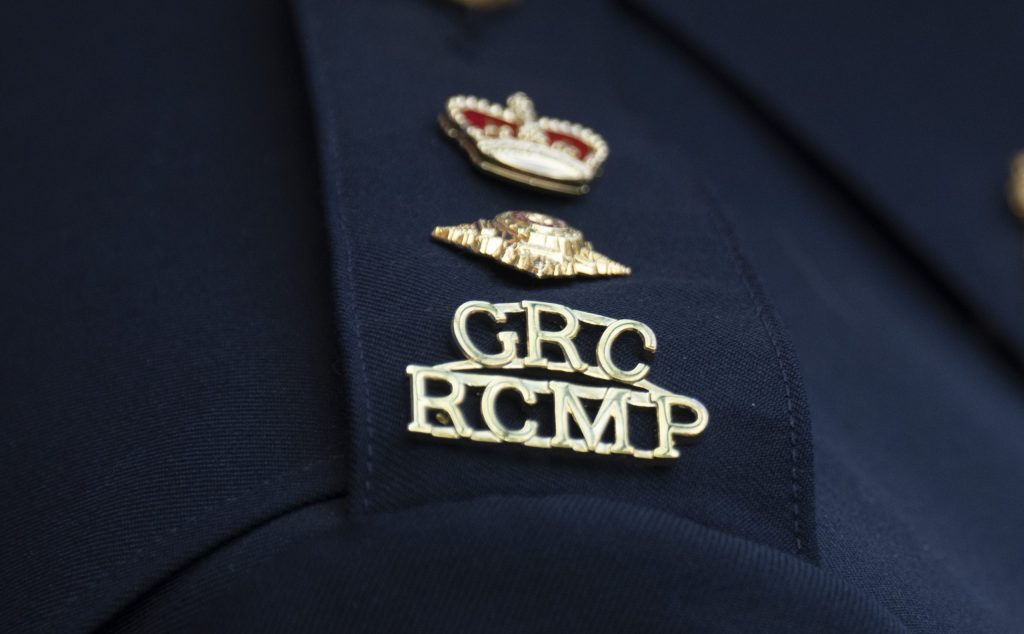 The RCMP logo is seen on the shoulder of a superintendent during a news conference