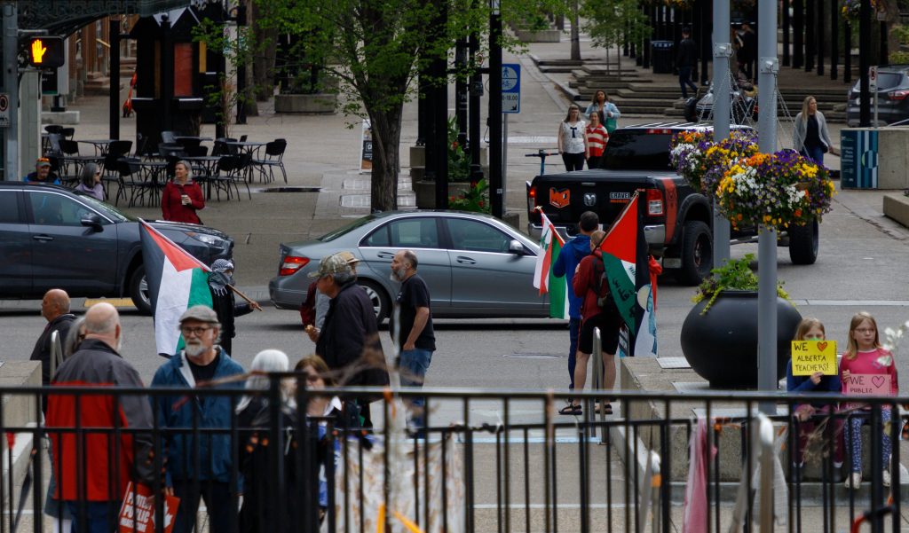 A small group of pro-Palestinian protestors protest feet away from a UCP protest at the Municipal Plaza in Calgary on Saturday, May 25, 2024. There were no counter-protestors present, and police presence was minimal.