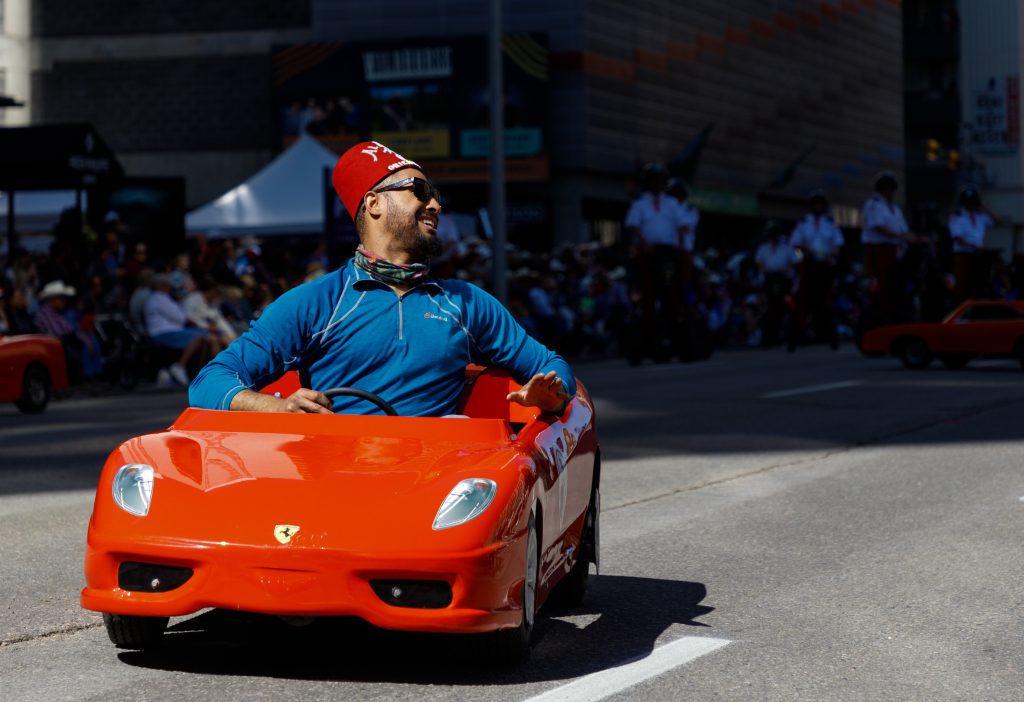 A member of the Calgary Shriners jests with the crowd as he drives on 7 Avenue in the 2024 Stampede Parade downtown Calgary on Friday, July 5, 2024.