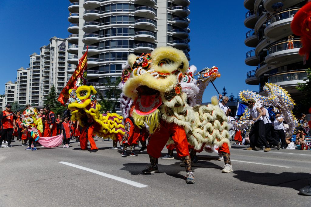 Chinese dragons stop to perform for the crowd at the 2024 Stampede Parade in downtown Calgary