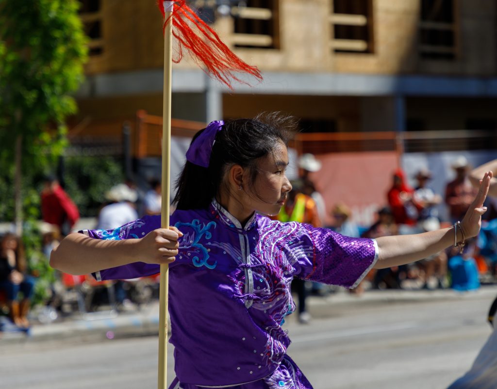 A martial artists from Calgary Tai Chi and Martial Arts College gets into a stance in the 2024 Stampede Parade kicks off in downtown Calgary on Friday, July 5, 2024