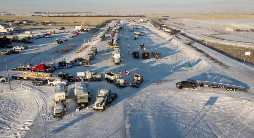 A truck convoy of anti-COVID-19 vaccine mandate demonstrators continue to block the highway at the busy U.S. border crossing in Coutts, Alta