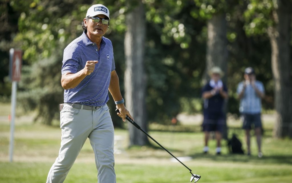 Ken Tanigawa, of the United States, reacts to a birdie putt on seventeenth green on his way to winning the PGA Tour Champions golf event in Calgary