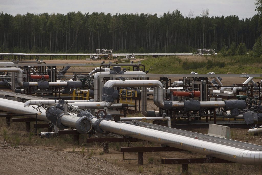 Suncor pipes that carry various liquids from their MacKay River pad in the oil sands in Fort McMurray Alta, on June 12, 2017. The group representing Alberta's rural municipalities says the province is trying to increase production from its declining conventional oil and gas fields at the expense of local tax bases, environmental oversight and the public interest. THE CANADIAN PRESS/Jason Franson