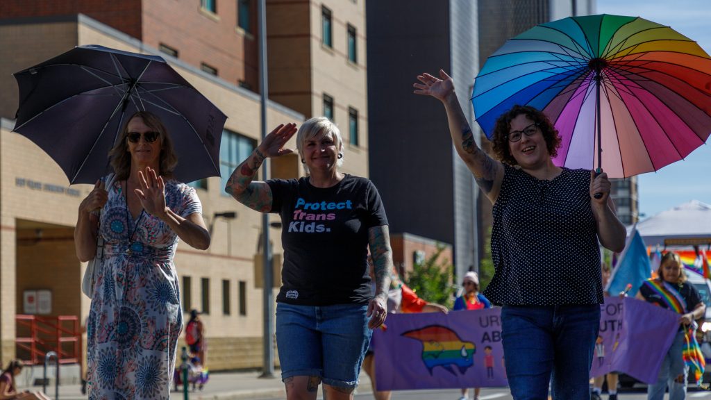 Calgary Pride Parade Marshalls April Friesen, left, Lindsey Peace, centre, and Amelia Newbert lead the Pride Parade in downtown Calgary