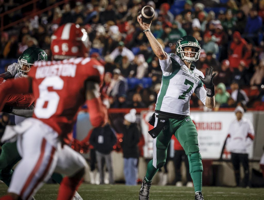 Saskatchewan Roughriders quarterback Trevor Harris (7) throws the ball as Calgary Stampeders' Demerio Houston (6) rushes in during second half CFL football action against the Calgary Stampeders in Calgary, Friday, Sept. 20, 2024