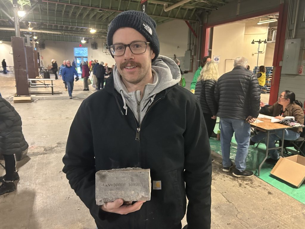 Peter Soroka displays the brick his parents purchased to support the 1988 Winter Olympics, in Calgary