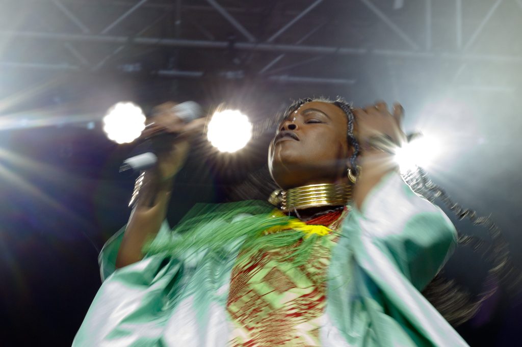 Gladys Samba dances to the beat on the ATB Main Stage on the third day of the Calgary Folk Music Festival at Prince's Island Park in Calgary on Saturday, July 26, 2025. She, along with four other members, make up 'Les Mamans du Congo.'