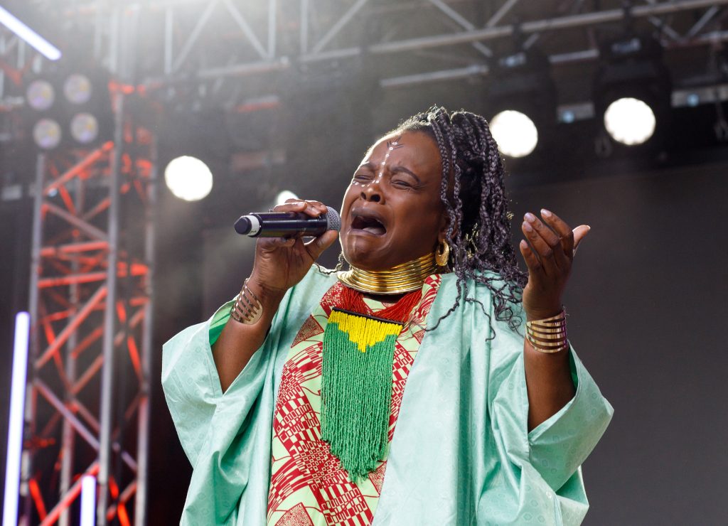 Gladys Samba sings on the ATB Main Stage on the third day of the Calgary Folk Music Festival at Prince's Island Park in Calgary on Saturday, July 26, 2025. She, along with four other members, make up 'Les Mamans du Congo.'