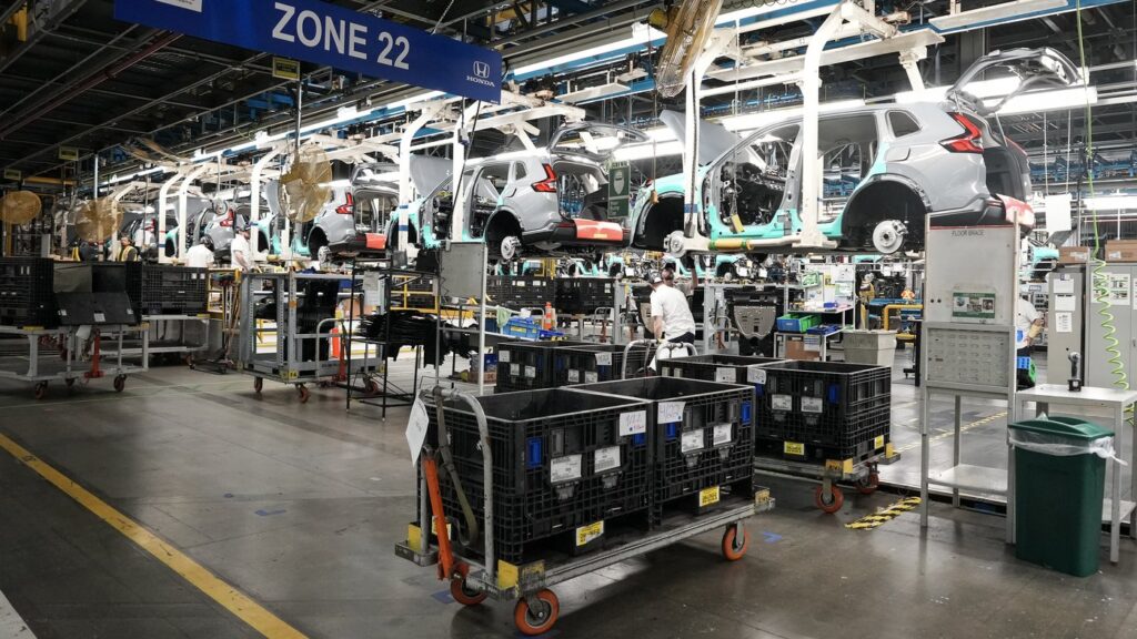 Honda employees work along the vehicle assembly line before an event announcing plans for a Honda electric vehicle battery plant in Alliston, Ont., on Thursday, April 25, 2024. THE CANADIAN PRESS/Nathan Denette