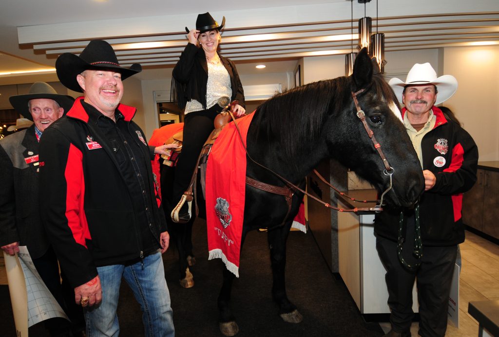 Members of the Calgary Grey Cup Committee pose for a photo with "Tuffy Nuff" the horse