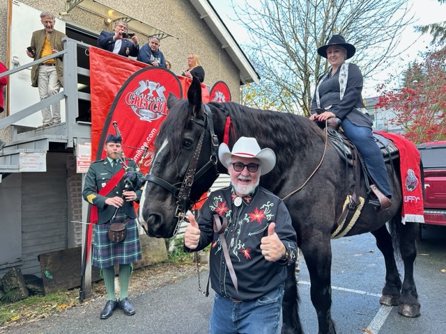 Members of the Calgary Grey Cup Committee pose for a photo with "Tuffy Nuff" the horse