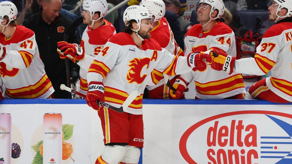 Calgary Flames defenseman Rasmus Andersson (4) celebrates his goal during the first period of an NHL hockey game against the Buffalo Sabres Wednesday, Nov. 19, 2025, in Buffalo, N.Y. (AP Photo/Jeffrey T. Barnes)