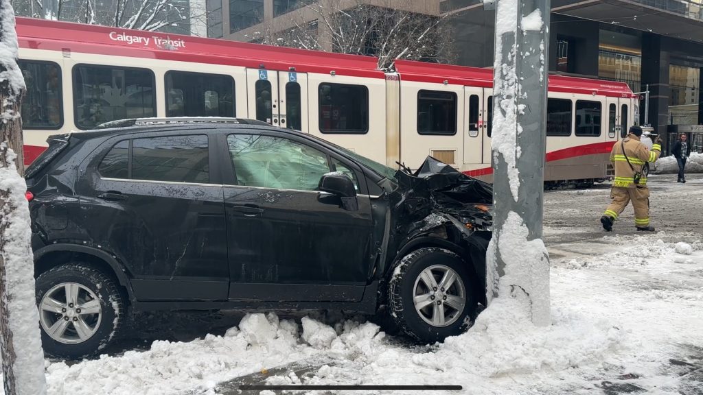 A vehicle struck a pole following a crash that shut down CTrain service along 7 Avenue SW on Nov. 24, 2025. (Matthew Johnson)