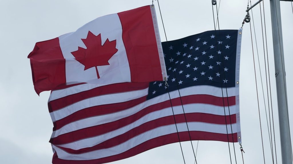 Flags of Canada and the United States are shown in San Francisco, Friday, Oct. 10, 2025. (AP Photo/Jeff Chiu)
