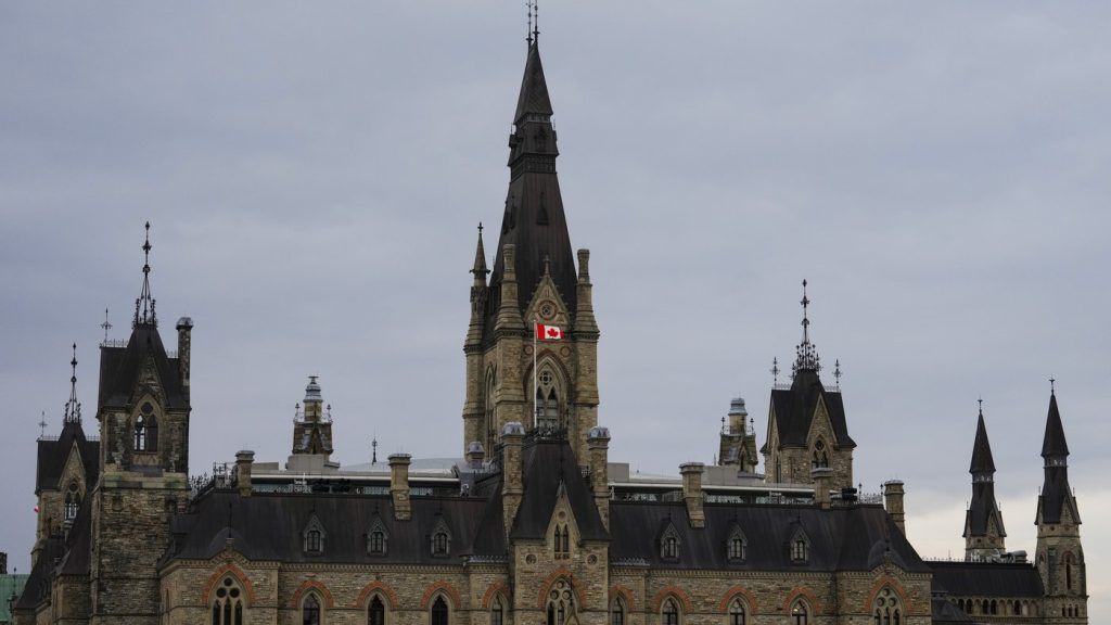 The Canadian flag flies on the roof of the West Block on Parliament Hill in Ottawa on Monday, Nov. 3, 2025. THE CANADIAN PRESS/Sean Kilpatrick