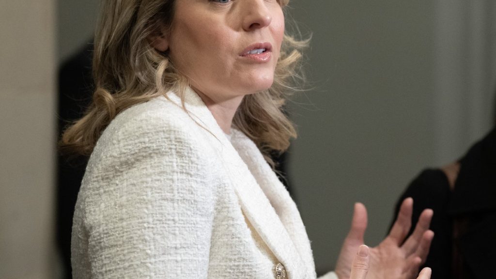 Industry Minister Melanie Joly speaks with reporters as she makes her way to a cabinet meeting on Parliament Hill, in Ottawa, Tuesday, Nov. 18, 2025. THE CANADIAN PRESS/Adrian Wyld