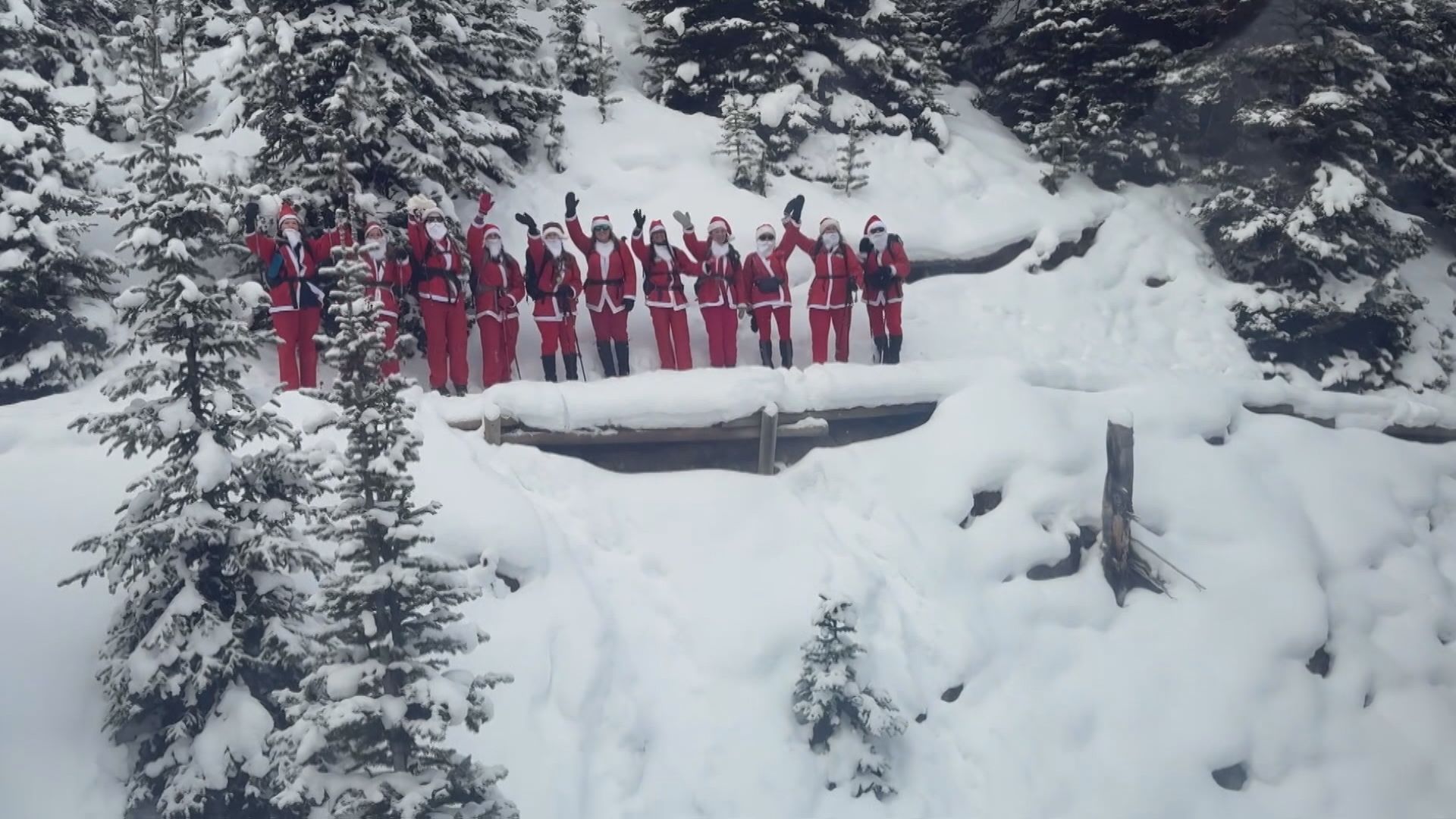 Summit Santa hikers pose for a drone shot while on Sulphur Mountain in Banff on Saturday, Dec. 6, 2025