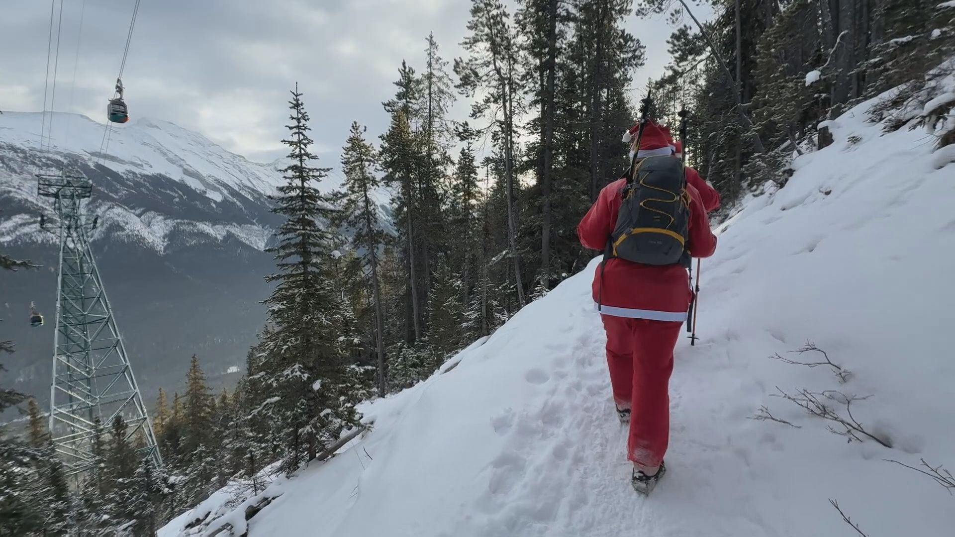 A Summit Santa hiker ascends Sulphur Mountain in Banff on Saturday, Dec. 6, 2025