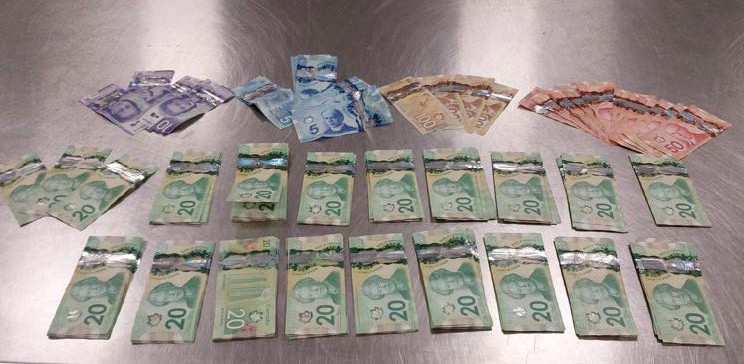 Around $5,000 in cash seized from a vehicle after police took two suspects into custody while in the Red Carpet community in Calgary, which happened on Thursday, Dec. 11, 2025