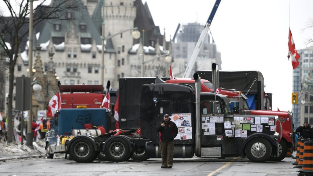 Trucks are seen in front of the Chateau Laurier hotel as a protest marked by gridlock and blaring horns reached its 14th day in Ottawa on Thursday, Feb. 10, 2022. THE CANADIAN PRESS/Justin Tang