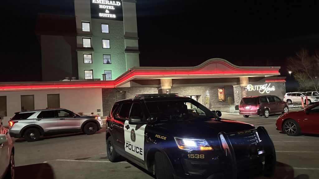 A Calgary Police Service vehicle parked in front of the Emerald Hotel and Suites in the city's northeast on Monday, May 18, 2026. (Noah Laycock, CityNews image)