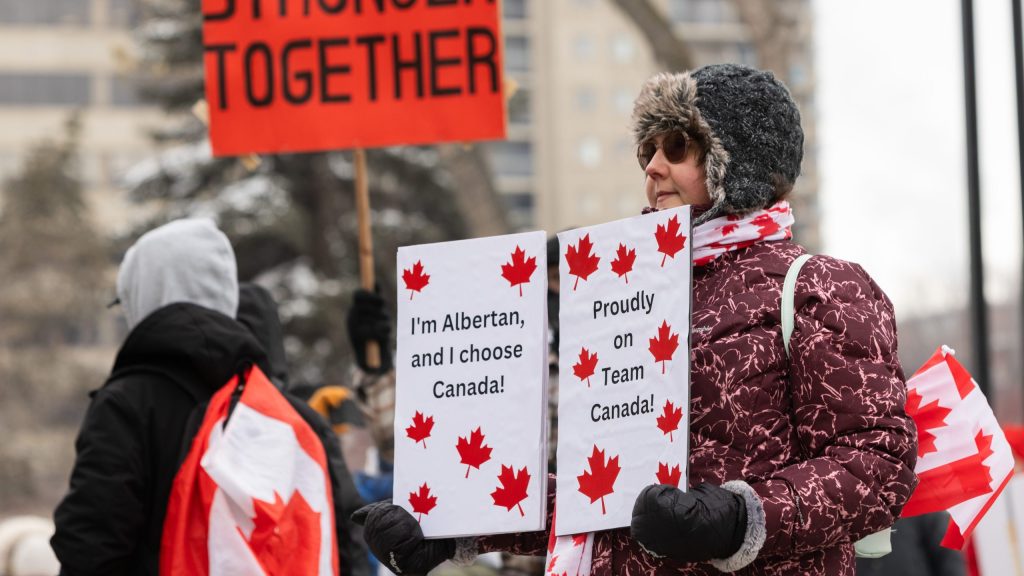 Lisa Budney holds a protest sign as people take part in a pro-Canada anti-separatist rally in Edmonton on Saturday, Feb. 21, 2026. THE CANADIAN PRESS/Ryan Jackson