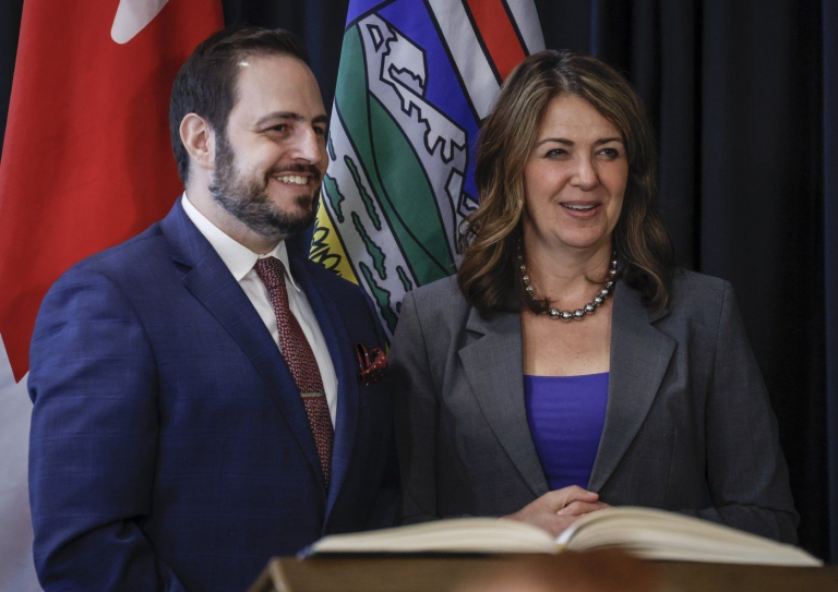 Alberta Premier Danielle Smith, right, stands with new Minister of Education and Childcare, Demetrios Nicolaides, following a swearing in ceremony in Calgary, Friday, May 16, 2025.THE CANADIAN PRESS/Jeff McIntosh